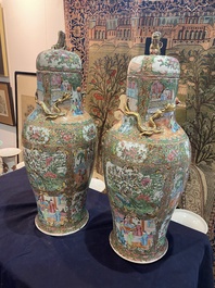 A pair of Chinese baluster shaped Canton famille rose vases with palace scenes and floral design, 19th C.