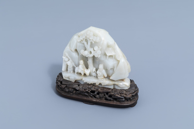 A Chinese double-sided celadon jade boulder with figures in a mountain landscape, 19th/20th C.