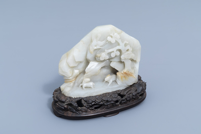 A Chinese double-sided celadon jade boulder with figures in a mountain landscape, 19th/20th C.