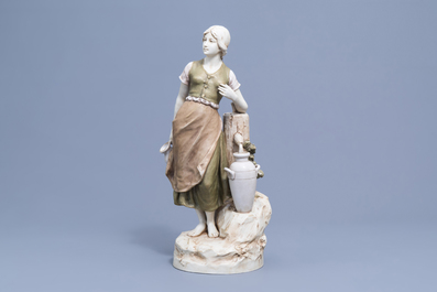 A polychrome decorated biscuit figure of a lady at a well, Royal Dux, 20th C.