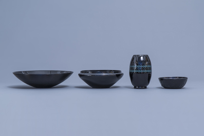 A varied collection of black glass vases and bowls, a.o. Art Deco 'Booms' glass, 20th C.