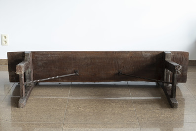 A rustic wooden bench and a Louis XVI style bed with carved floral design, 19th/20th C.