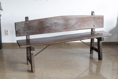 A rustic wooden bench and a Louis XVI style bed with carved floral design, 19th/20th C.