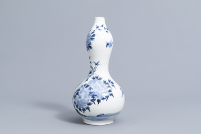 A Japanese blue and white Arita double gourd vase with birds among blossoming branches all around, Meiji, ca. 1900