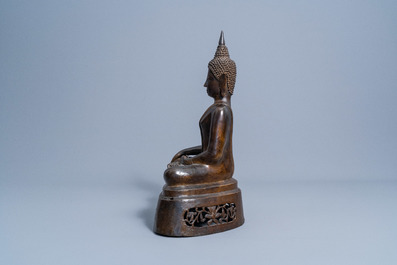 A Thai patinated bronze figure of a seated Buddha, 19th C.