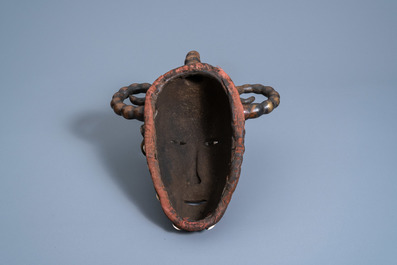 A bronze Senufo mask with cowry shells, Burkina Faso or Mali, 20th C.