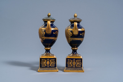 A pair of Vienna gold layered blue ground vases and covers with the portraits of 'Madame de Montosson' and 'Madame Elisabeth', 19th/20th C.
