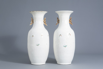 A pair of Chinese qianjiang cai vases with figures in a garden, 20th C.