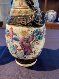 A pair of fine Chinese Nanking crackle glazed famille rose vases with warrior scenes and dragons chasing the pearl, 19th C.