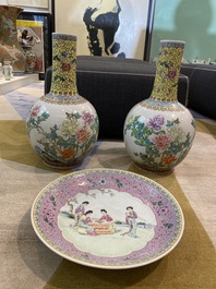 A pair of Chinese famille rose bottle vases with floral design and a charger with ladies in a garden, Republic, 20th C.