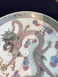 Three Chinese famille rose chargers with floral design and a dragon, 19th/20th C.