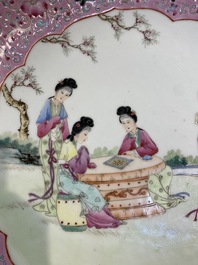 A pair of Chinese famille rose bottle vases with floral design and a charger with ladies in a garden, Republic, 20th C.