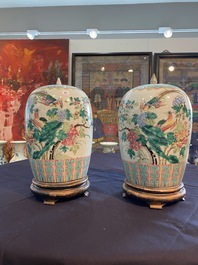 A pair of Chinese famille rose jars and covers with birds among blossoming branches, 19th C.