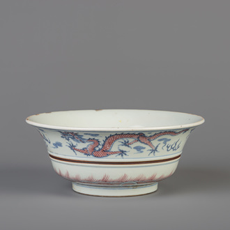 A Chinese blue, white and copper red 'dragon and phoenix' bowl, Kangxi mark, 19th/20th C.