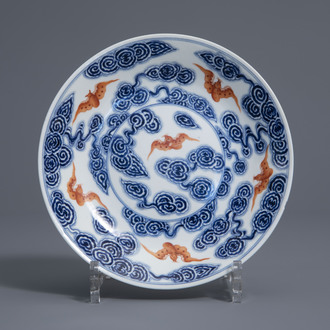 A Chinese blue, white and iron red 'bats and clouds' plate, 19th/20th C.
