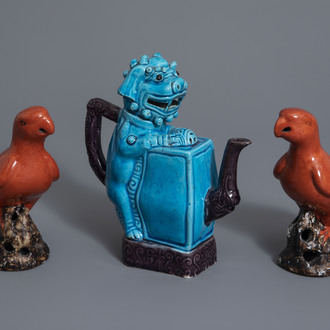 A Chinese turquoise and aubergine glazed Buddhist lion shaped teapot and a pair of red glazed parrots, 20th C.