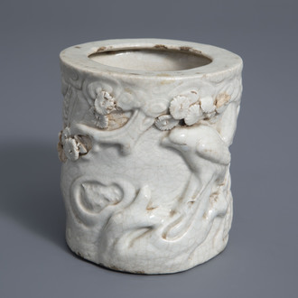 A Chinese monochrome crackle glazed relief decorated brush pot, 19th C.