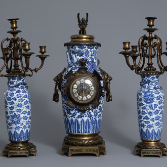 A Chinese three-piece bronze mounted blue and white porcelain garniture, 19th C.
