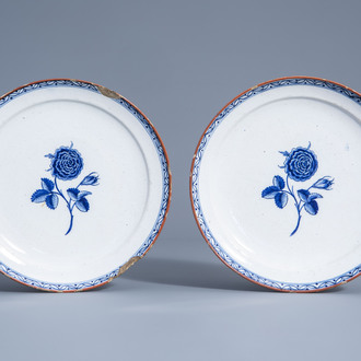 A pair of Dutch Delft blue and white plates with roses, 18th C.