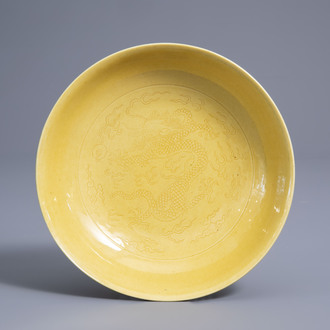 A Chinese monochrome yellow incised 'dragon' saucer dish, Daoguang mark and of the period
