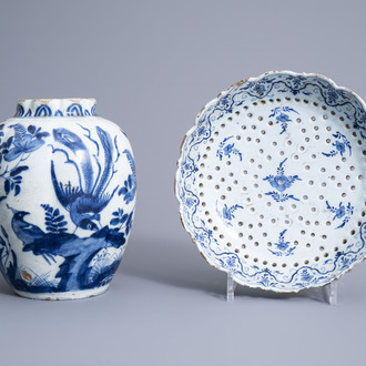 A Dutch Delft blue and white strainer and a vase with birds among blossoming branches, 18th C.