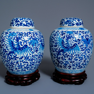 A pair of Chinese blue and white 'phoenix' jars and covers with floral design, Kangxi mark, 19th C.