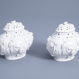 A pair of French soft paste Mennecy porcelain pot-pourri vases and covers with floral relief design, 18th C.