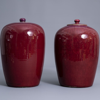 Two Chinese monochrome sang de boeuf glazed jars and covers, 19th C.