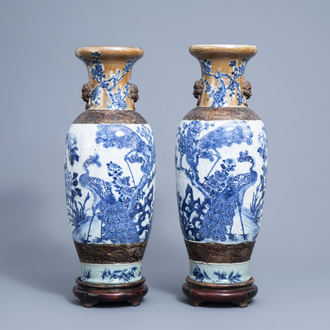A pair of Chinese blue and white Nanking crackle glazed vases with peacocks among blossoming branches, 19th C.