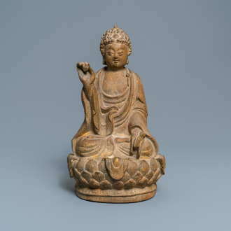 A Chinese sandstone figure of Buddha with traces of polychrome and gilt decoration, Qing