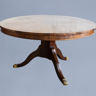 A circular English Regency mahogany tripod breakfast table wit a star veneered top, ca. 1810
