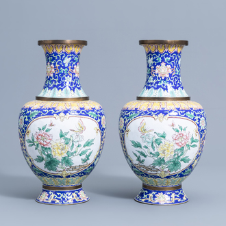 A pair of Chinese baluster shaped Canton enamel vases with butterflies among blossoming branches, 20th C.
