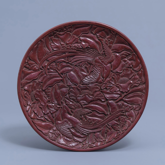 An inscribed Chinese red lacquered charger with birds among blossoming branches, 20th C.