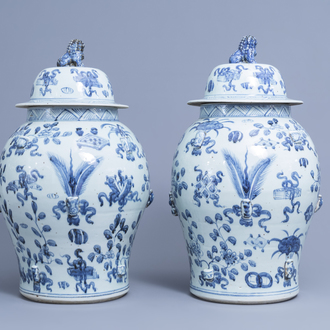 A pair of Chinese blue and white vases and covers with antiquities and floral design, 20th C.