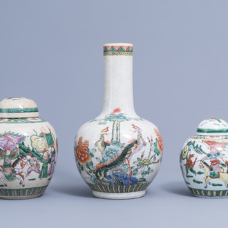 A Chinese bottle shaped Nanking crackle glazed famille verte vase and two jars and covers with warrior scenes, 19th/20th C.