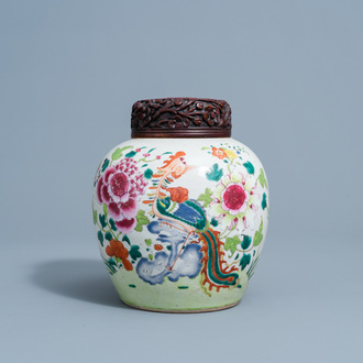 A Chinese famille rose jar and cover with a phoenix among blossoming branches, 19th C.