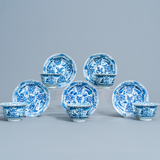 Five Chinese blue and white cups and saucers with landscapes and floral design, Kangxi mark, 19th C.