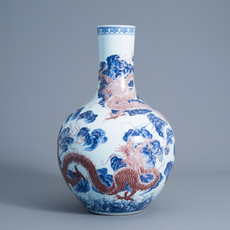 A large Chinese blue, white and copper red bottle shaped 'dragon' vase, Qianlong mark, 19th/20th C.