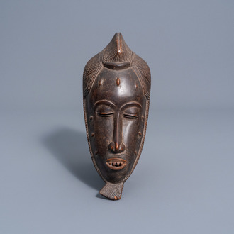 A wooden anthropomorphic 'gu' mask, Guro, Ivory Coast, 20th C.