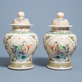 A pair of Chinese Nanking crackle glazed famille rose 'Liu Hai' vases and covers, 19th C.