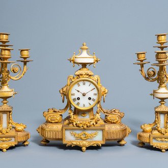 A French Louis XVI style three-piece gilt bronze and alabaster clock garniture, ca. 1900