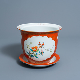A Chinese famille rose coral red ground jardinière on stand with floral design, 20th C.