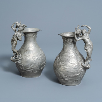Charles Théodore Perron (1862-1934): A pair of Art Nouveau pewter 'nymphs and cherubs' pitchers with relief design, France, dated 1895