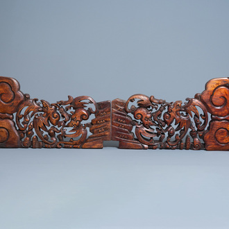 A pair of Chinese carved wooden ornaments with bats, 20th C.