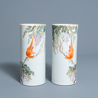 A pair of Chinese qianjiang cai hat stands with a bird on a blossoming branch, 19th/20th C.
