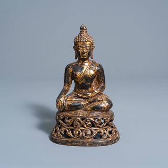 A gilt lacquered bronze figure of Buddha Shakyamuni on a reticulated lotus throne, probably Thailand, 19th C.