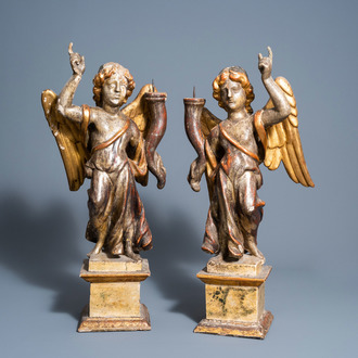 A pair of Italian carved, polychrome painted and gilt wood angel shaped candlesticks, 18th C.