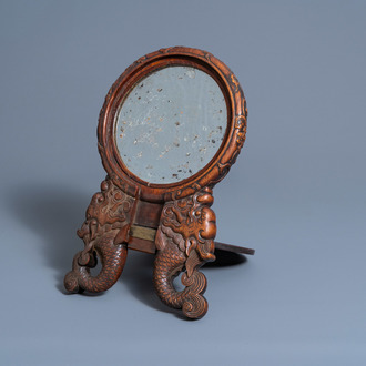 A Chinese carved wood mirror with dragons and figures, ca. 1900