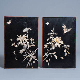 A pair of Chinese lacquer panels with birds and butterflies among blossoming branches in mother-of-pearl, 20th C.