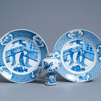 A pair of Chinese blue and white plates with ladies in a garden and a vase with floral design, Kangxi